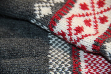 Woolen grey gloves with Christmas pattern close-up