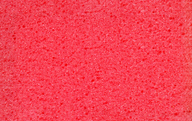 Texture of red dishwashing sponge. Abstract red background.