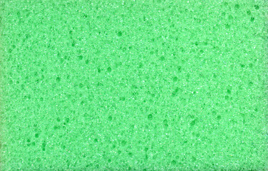 Texture of green dishwashing sponge. Abstract green background.