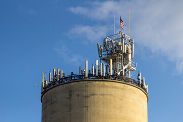 5G cell phone tower on top of barn silo with American flag.