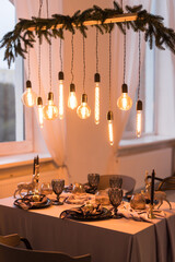 Close up of festive Christmas table setting with empty wine glasses and black plate