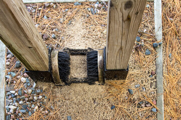 Stop Invasive Species. Boot brush for hikers at a trailhead in the Hiawatha National Forest. The brush allows hikers to brush off their boots to prevent carrying invasive plant species into the woods.