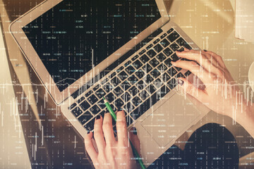 Double exposure of woman hands working on computer and forex chart hologram drawing. Top View. Financial analysis concept.