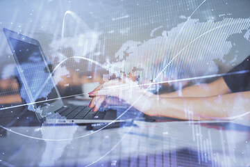 Double exposure of businesswoman hands typing on computer and forex chart hologram drawing. Financial analysis concept.