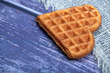 Delicious homemade cookies on the background of rough homespun fabric. Close-up, selective focus.