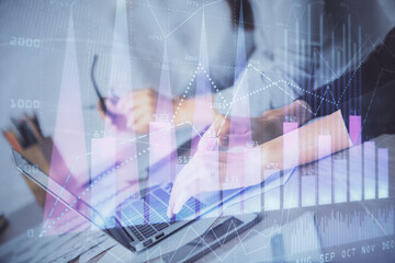 Multi exposure of woman hands typing on computer and financial chart hologram drawing. Stock market analysis concept.