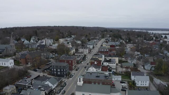 Main Street, East Greenwich Rhode Island, drone aerial cityscape, traffic and plane flying