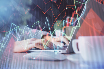 Double exposure of woman hands typing on computer and forex chart hologram drawing. Stock market invest concept.