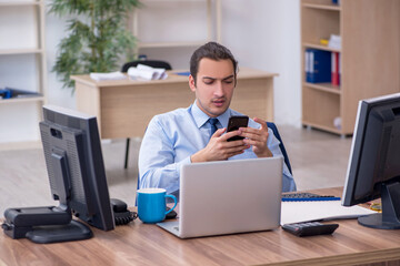 Young male employee working in the office