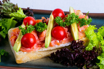 Delicious italian bruschetta with salmon and avocado.