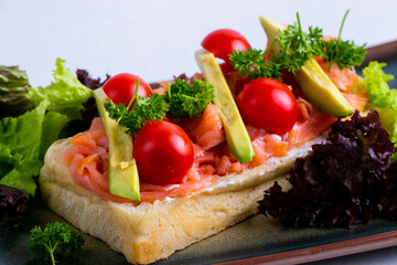 Delicious italian bruschetta with salmon and avocado.