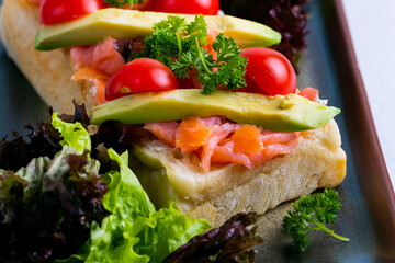 Delicious italian bruschetta with salmon and avocado.