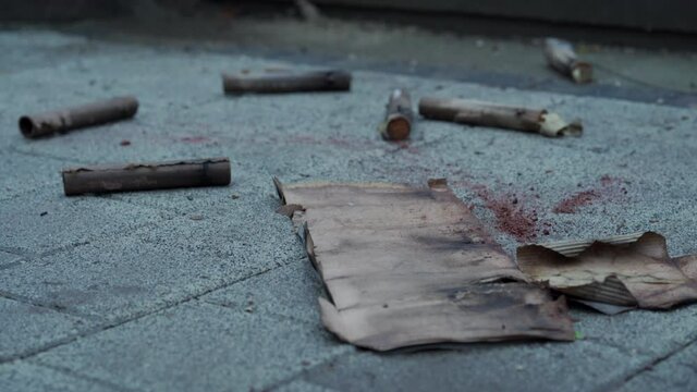 Used burnt fireworks, firecrackers on pavement after explosion in holiday, Birthday, New Year, Christmas celebrations.