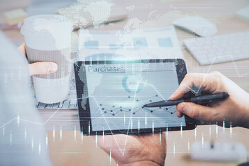 Double exposure of man's hands holding and using a phone and financial chart drawing. Market analysis concept.