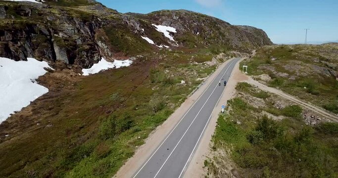 Men cycling on coastal road, aerial view. High quality 4k footage