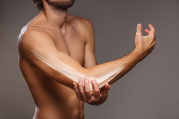 Arm pain, the person is holding the painful elbow
