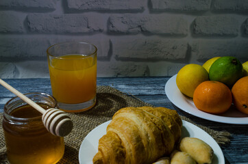 Still life with fresh fruits and glass of juice on the wooden background