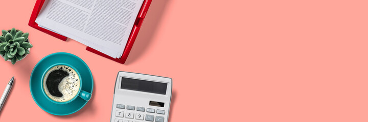 Top view of a workplace with office supplies on a peach background