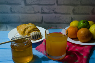 Still life with fresh fruits and glass of juice on the wooden background