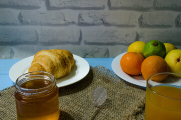 Still life with fresh fruits and glass of juice on the wooden background