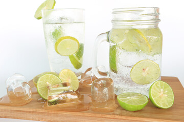 Health care, fitness, healthy nutrition diet concept. Fresh cool lemon infused water, detox drink, lemonade in a glass jug and a glass.