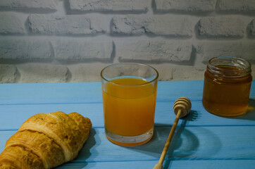 Still life with fresh fruits and glass of juice on the wooden background