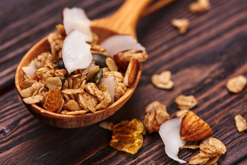 Granola in a wooden spoon