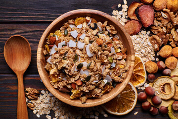 Granola and dried fruits with nuts on a wooden table
