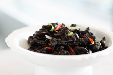 an appetiser of Fungus with Preserved Vinegar served in a white china plate