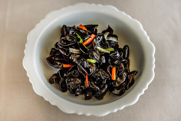 an appetiser of Fungus with Preserved Vinegar served in a white china plate