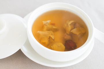 an appetizer of Double-boiled Conch and Red Date Soup served in a white china bowl