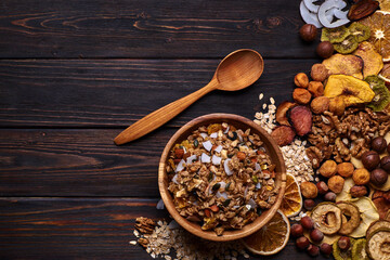 Granola and dried fruits with nuts on a wooden table