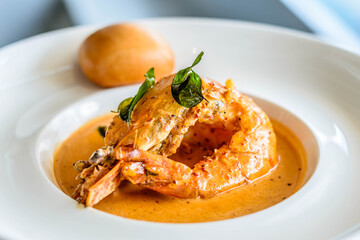 main course of King Prawn served in Bang Sauce with a bun