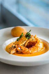 main course of King Prawn served in Bang Sauce with a bun