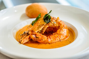 main course of King Prawn served in Bang Sauce with a bun