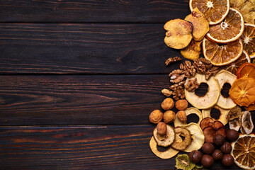 Fototapeta na wymiar Mix of dried fruits and nuts on a wooden table