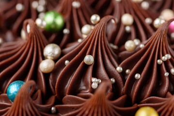 A rich indulgent chocolate cake top with chocolate swirls and brightly coloured candy