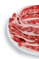 Fresh beef short plate slice on black plate, isolated on white background