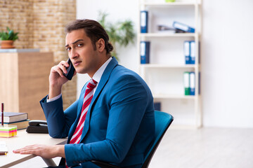 Young male employee working in the office