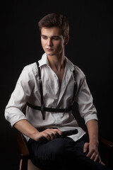 Handsome casual man sitting on a black