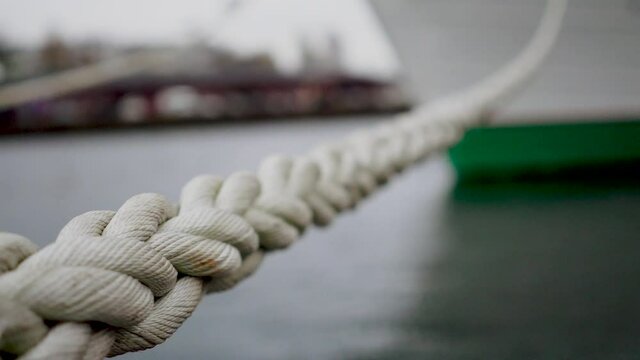 Close-up of part of twisted rope. Macro photography of villi of twisted rope on blurry background. White ship mooring Rope keeps the boat or ship anchored along the shore