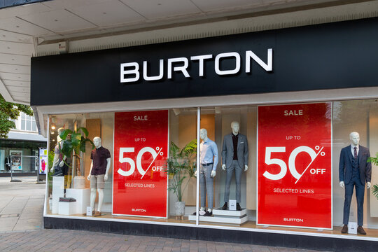06/06/2019 Portsmouth, Hampshire, UK A Burton store sign above dressed mannequins and sale posters in the window