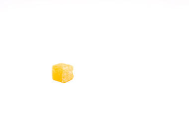 Cube of yellow rahat Turkish delight on a white background