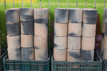 Coal briquet cylindrical solid fuel mixed. briquettes are piled up.