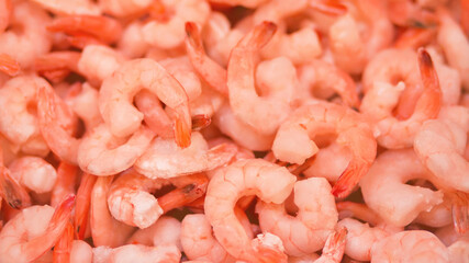 Frozen peeled shrimp are in the grocery store in large quantities. Sale of marine products.