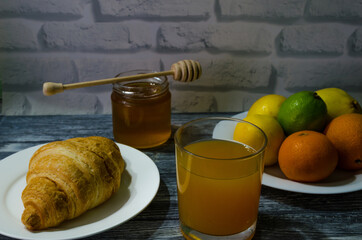 Still life with fresh fruits and glass of juice on the wooden background