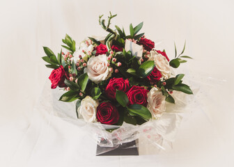 A spring flower arrangement with both red and white naomi roses