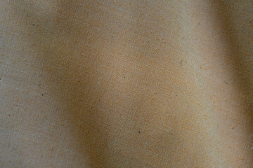 Background and texture of the old fabric is cream colored fabric. Undulating 