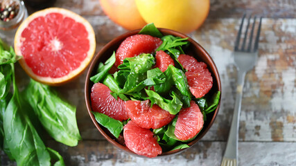 Selective focus. Spinach grapefruit salad in a bowl. Healthly food. Vegan snack.