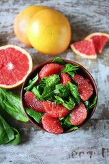 Selective focus. Spinach grapefruit salad in a bowl. Healthly food. Vegan snack.